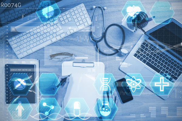 Data science tools and frameworks is depicted by a birds eye view of a desk with a laptop & stethoscope show suggest data science.
