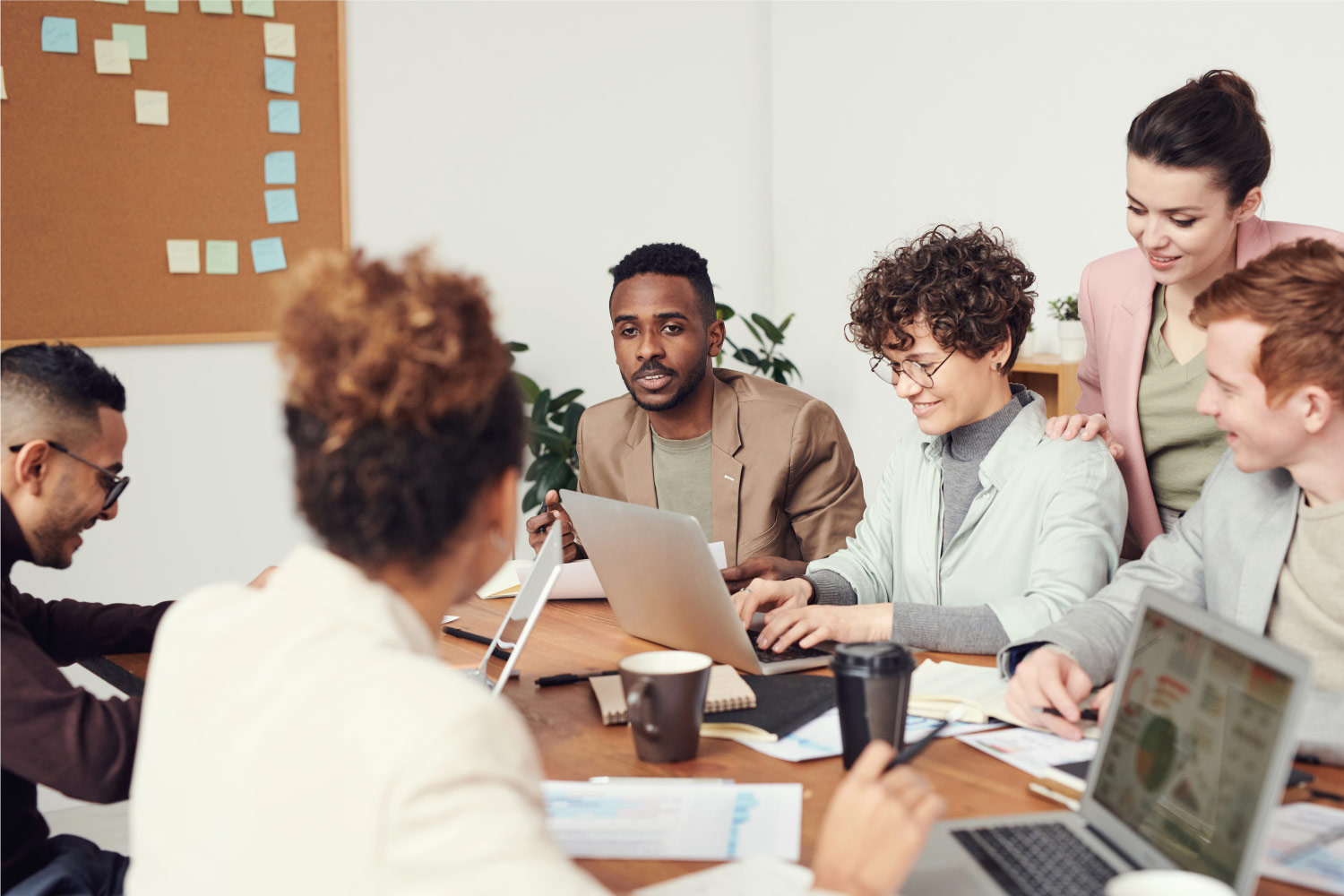 people working sitting around a table